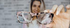 Girl Holding Up Glasses